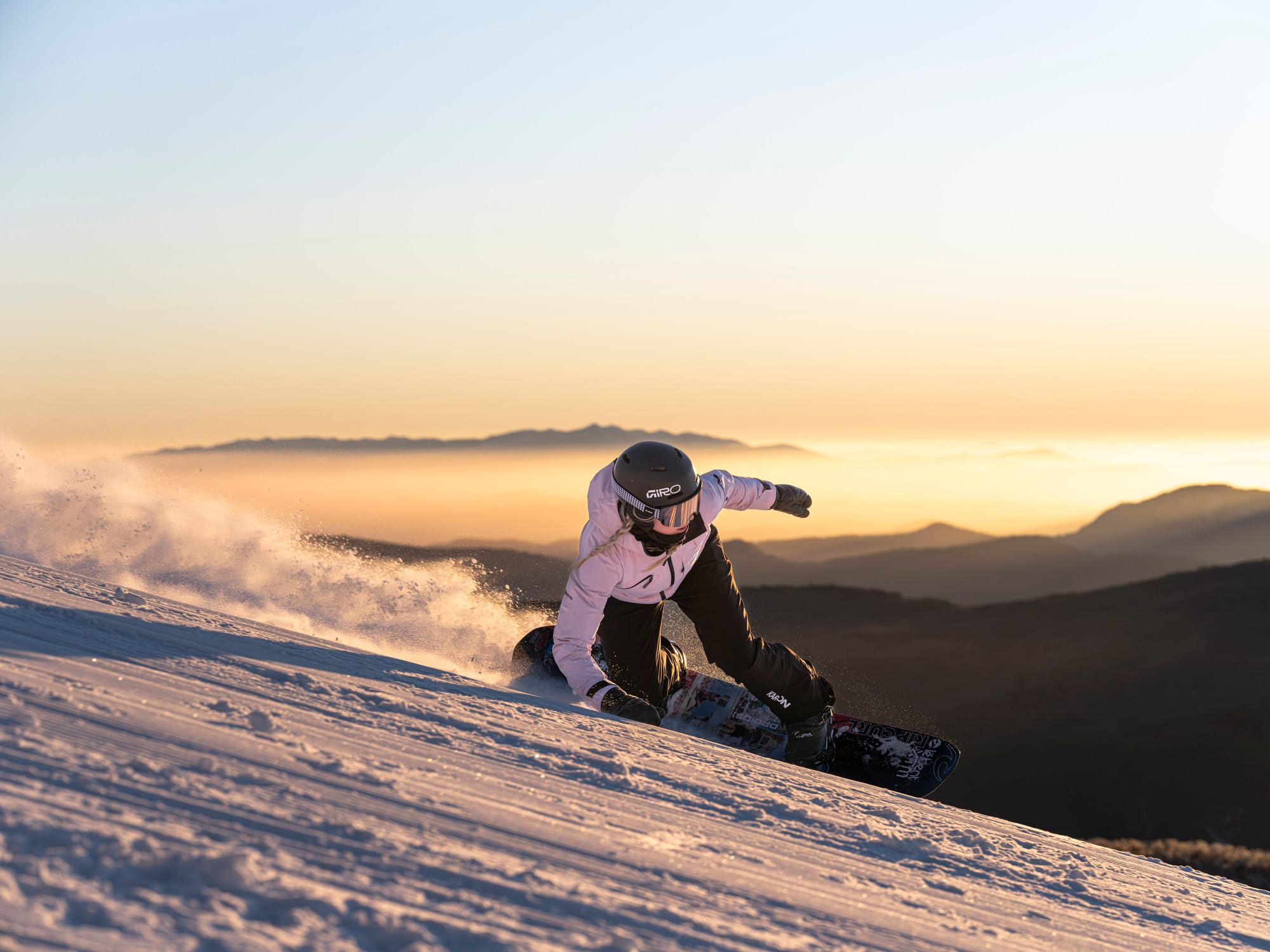 BRILILIANT LIGHT: Will McCarthy skims the slopes in an early morning run as the sun rises over the peaks.
