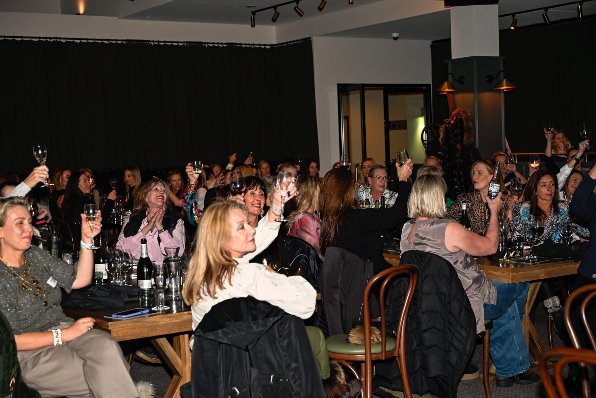 HERE'S CHEERS: Giving a cheer for the successful night all joined in.