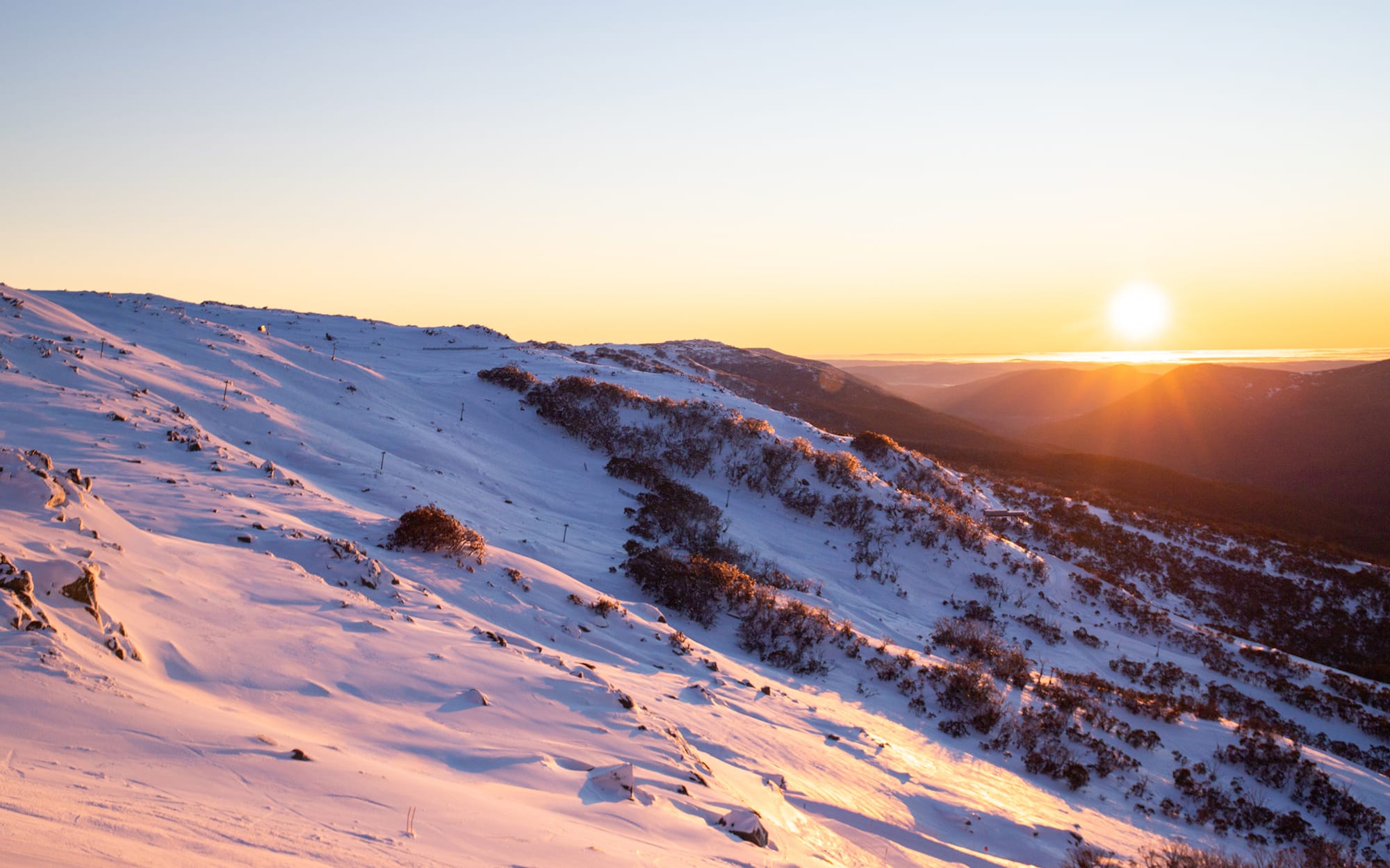 Watch the sunrise over Thredbo mountain.