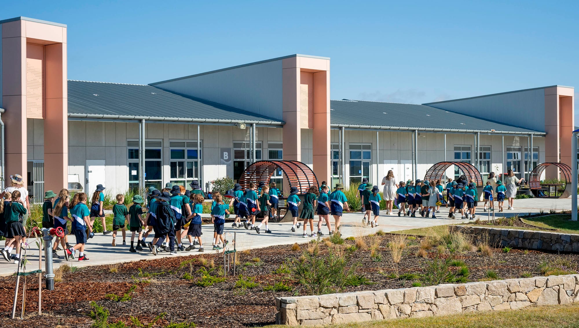 Primary school kids walk to their classroom.