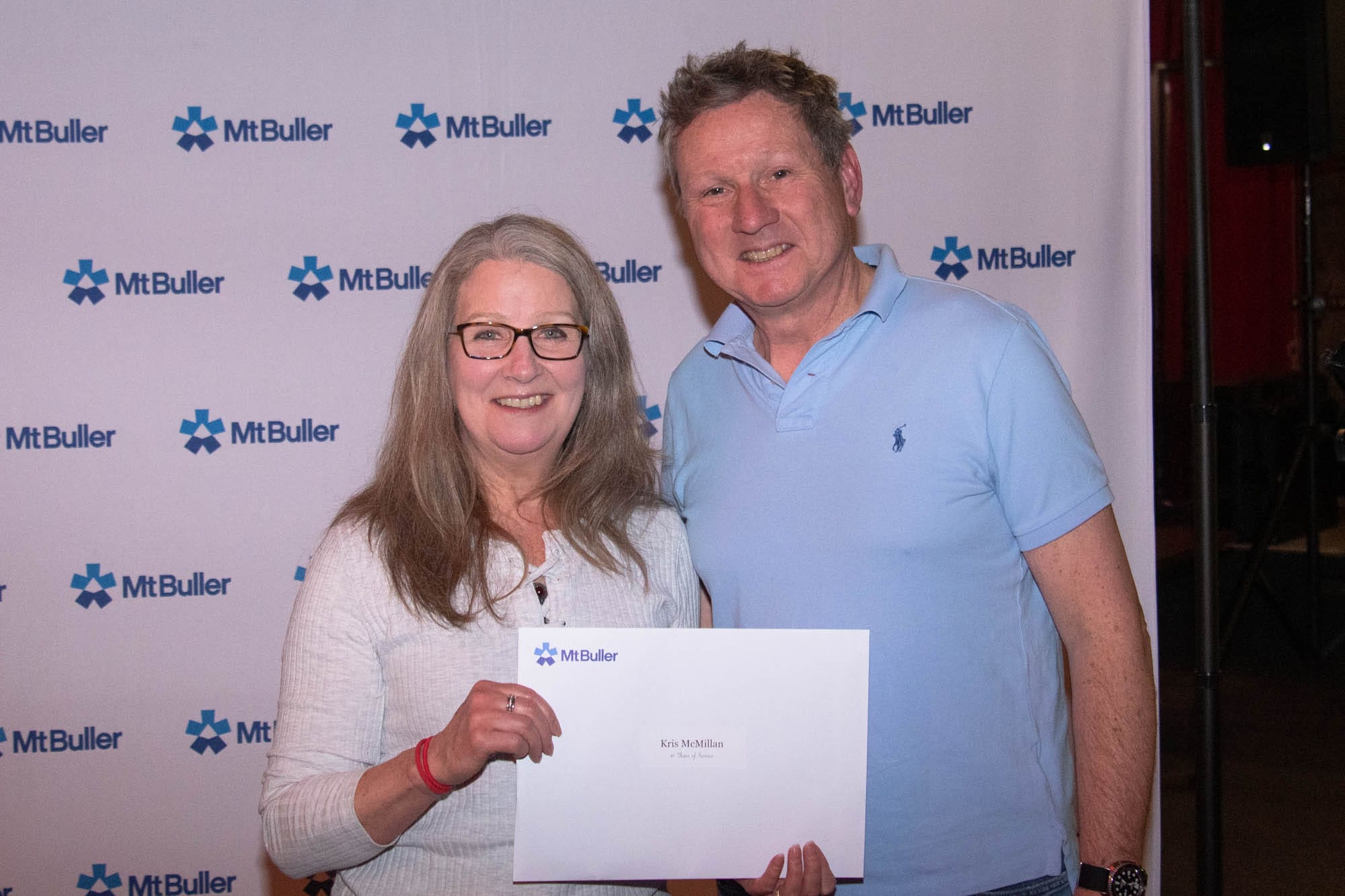 WELL DONE: Kris McMillan (left) who stacked up 40 years and Ed Mahon ski patrol manager. 