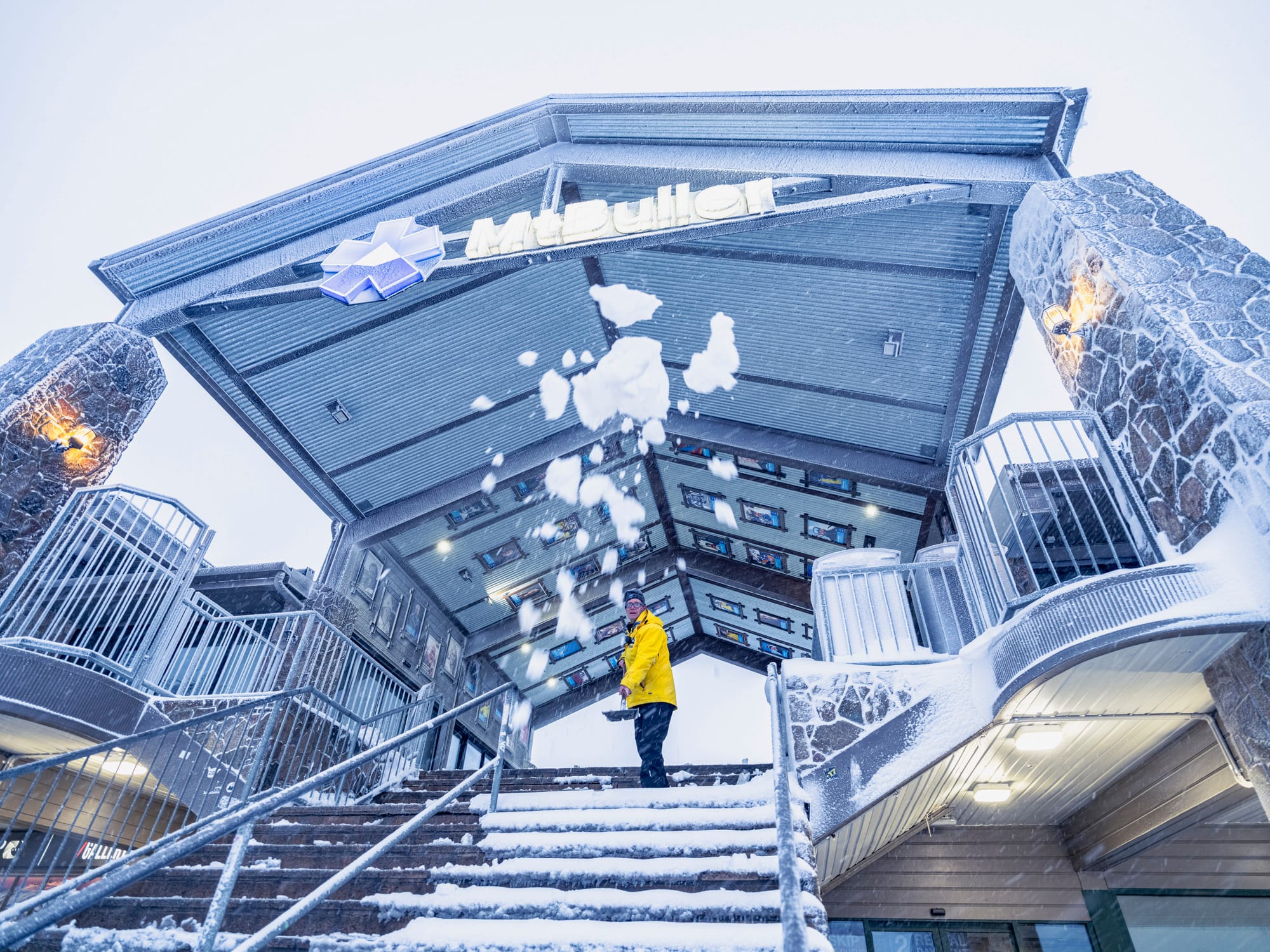 CLEARING THE STEPS: Safety in mind the steps of the Cattleman's rails are cleared of snow. The mountain's guest services folk help out where they can.